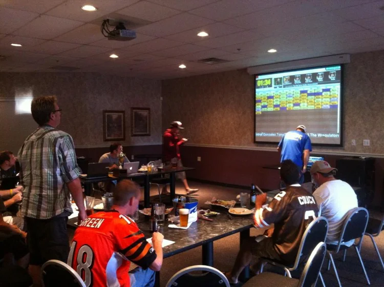 A FanDraft fantasy football draft board on a living-room TV