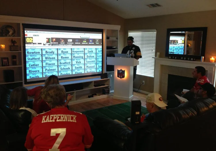 A FanDraft user fantasy football draft displayed on a TV