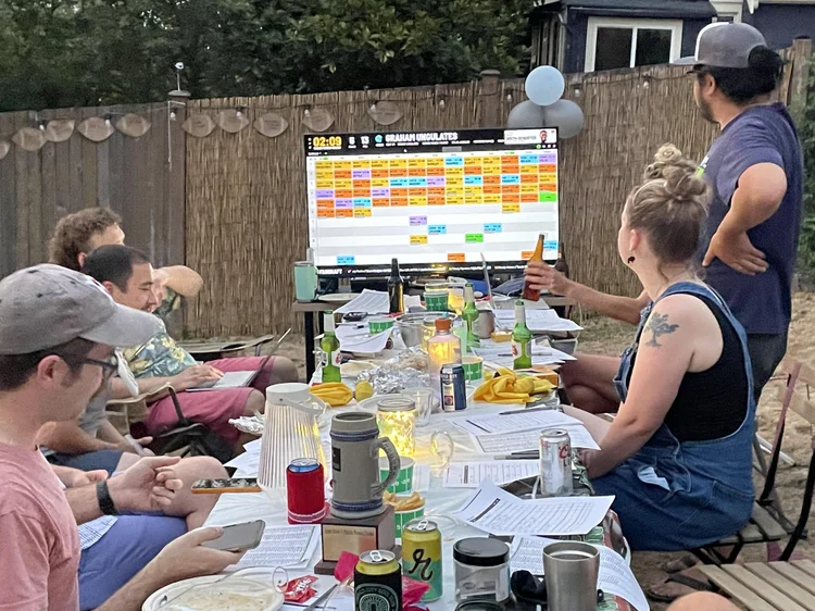 A FanDraft fantasy football draft party in 2022 shown on a big screen